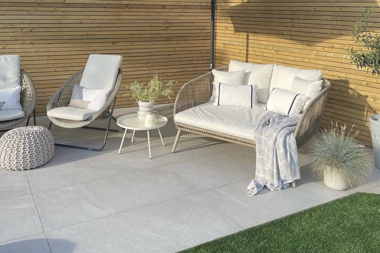 Chorus White paving beneath pale garden chairs beside a timber fence